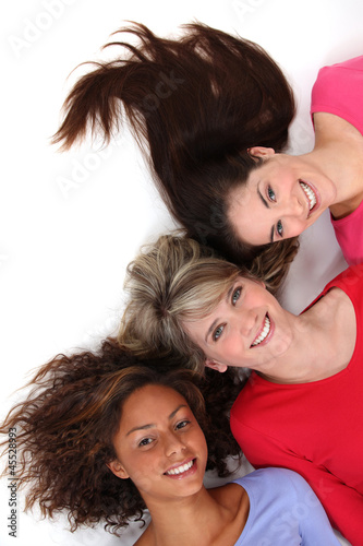 Photo: Three female friends laying next to each other Three female friends laying next to each other