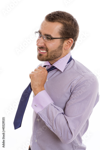 Photo: Portrait of anxious businessman loosening his necktie. Portrait of anxious businessman loosening his necktie.