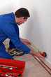 Photo: Plumber measuring a wall Plumber measuring a wall