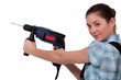 craftswoman holding a drill