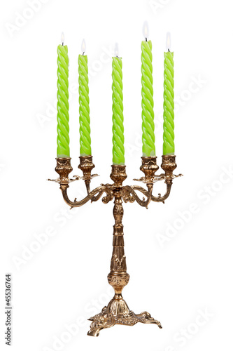 Photo: Vintage antique candelabrum with burning candles isolated Vintage antique candelabrum with burning candles isolated
