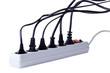 Many plugs plugged into electric power bar