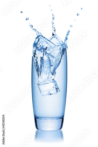 Photo: Ice cube splashing into a glass of water. Ice cube splashing into a glass of water.