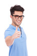 young man holding thumbs up