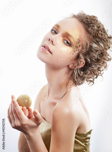 Photo: Fashion woman - beauty gilded golden make-up. Luxury curly hair Fashion woman - beauty gilded golden make-up. Luxury curly hair
