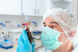 Scientist holds experimental mouse
