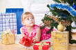 Photo: girl with gifts near a New Year tree girl with gifts near a New Year tree