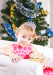 Photo: girl with gifts near a New Year tree girl with gifts near a New Year tree