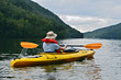 Woman Kayaking on Mountain Lake