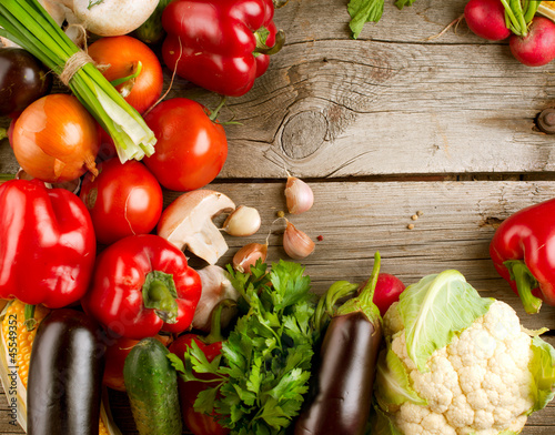 Photo: Healthy Organic Vegetables on the Wooden Background Healthy Organic Vegetables on the Wooden Background