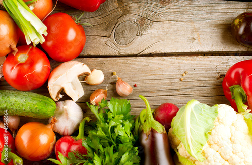 Photo: Healthy Organic Vegetables on a Wood Background Healthy Organic Vegetables on a Wood Background