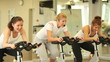 Video: Sport group of women on bicycles with trainer in center Sport group of women on bicycles with trainer in center