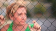 woman behind  fence  wires