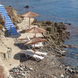 blue stairs to tranquil beach with umbrellas and chairs
