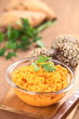 Sweet potato spread in glass bowl garnished with parsley