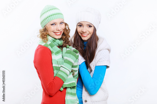 Photo: Young woman wearing winter hat and warm scarf Young woman wearing winter hat and warm scarf