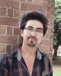 Portrait of a happy Indian / Asian college student in campus.