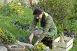 A young woman looks after the alpine slide in the garden