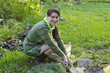 A young woman looks after the alpine slide in the garden