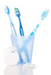 Toothbrushes, chewing gum and dental floss isolated on white