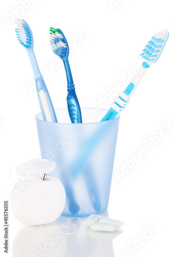 Photo: Toothbrushes, chewing gum and dental floss isolated on white Toothbrushes, chewing gum and dental floss isolated on white