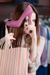 Woman plays with excellent fuchsia shoes at the store