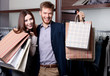 Foto: Cheerful couple show their purchases after shopping Cheerful couple show their purchases after shopping