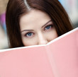 Female student reads the book at the library