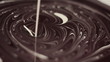 Pouring white cream into molten chocolate