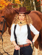Happy cowgirl with her sorrel horse.