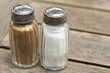 Salt-cellar and pepper-caster on wooden table
