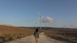 woman walking to wind energy