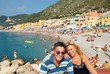 Man and woman with Varigotti beach in the background