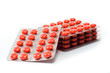 Orange tablets in packs on a white background. Vitamins.