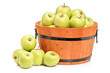 A studio shot of green apples in a wooden basket