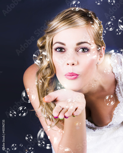 Photo: Playful Bride Blowing Bubbles At Wedding Reception Playful Bride Blowing Bubbles At Wedding Reception