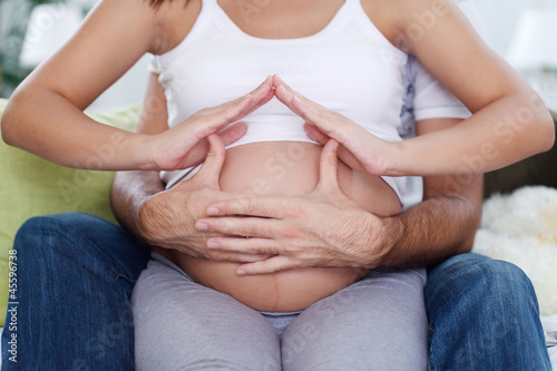 Photo: Home symbol on pregnancy belly Home symbol on pregnancy belly