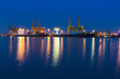 Container Cargo freight ship with working crane bridge in shipya