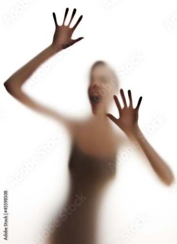Photo: silhuette of a screaming woman - danger concept silhuette of a screaming woman - danger concept