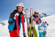 Skiing, winter fun - happy skiers on ski holiday