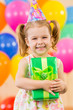 girl  with colorful balloons and gift