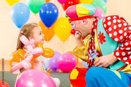 Photo: happy child girl and clown playing on birthday party happy child girl and clown playing on birthday party