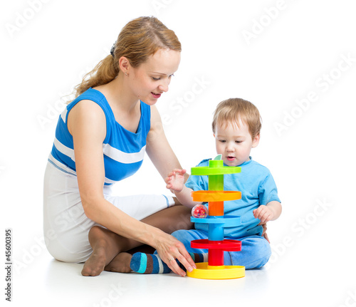 Photo: baby boy and mother playing together with puzzle toy baby boy and mother playing together with puzzle toy