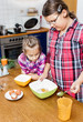 Photo: Two sister cooking together,baking for Christmas Two sister cooking together,baking for Christmas