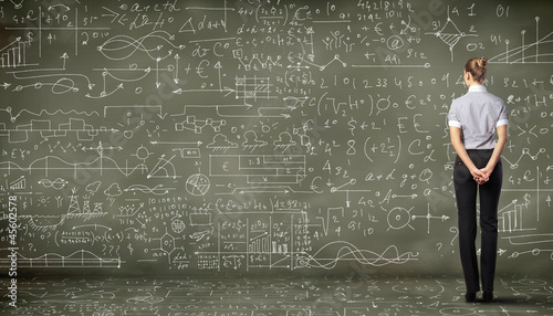 Photo: Business person against the blackboard Business person against the blackboard