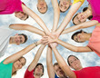 Photo: Happy joyful friends forming a circle with their hands in center Happy joyful friends forming a circle with their hands in center