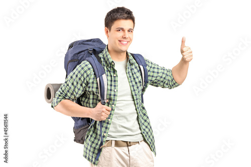 Photo: A male hiker with backpack giving a thumb up A male hiker with backpack giving a thumb up
