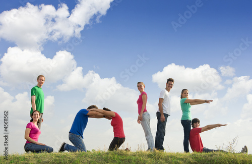 Photo: Group of people spelling word LOVE outdoors in nature Group of people spelling word LOVE outdoors in nature
