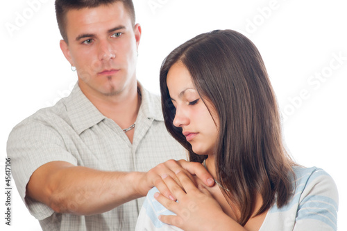 Photo: Young man supporting his sad girlfriend isolated on white Young man supporting his sad girlfriend isolated on white