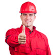 Young smiling fireman with hard hat and in full uniform